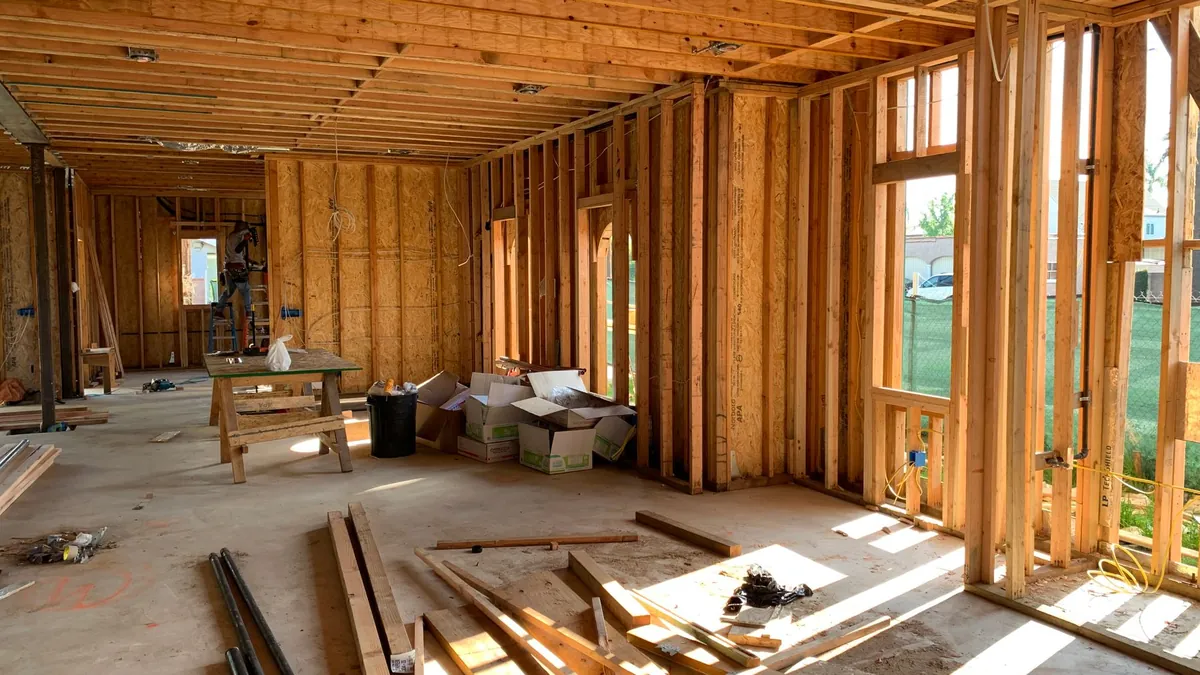 Open stud framing inside a house, ready for insulation
